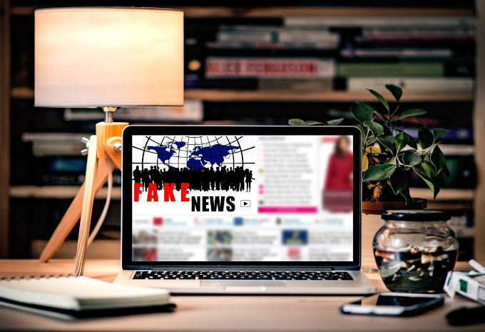 A Laptop On A Computer Desk Displaying &Quot;Fake News&Quot;