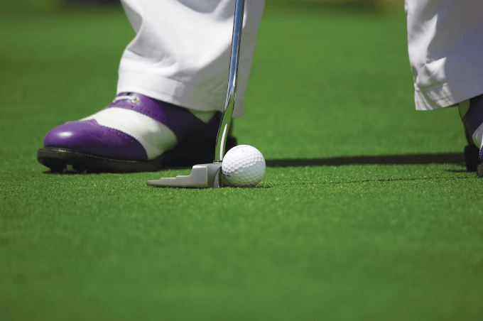 Golfer Putting On The Green